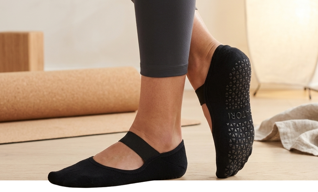 Black Satori ballet grip socks with single strap design, offering non-slip comfort and elegant support for Pilates and Barre.