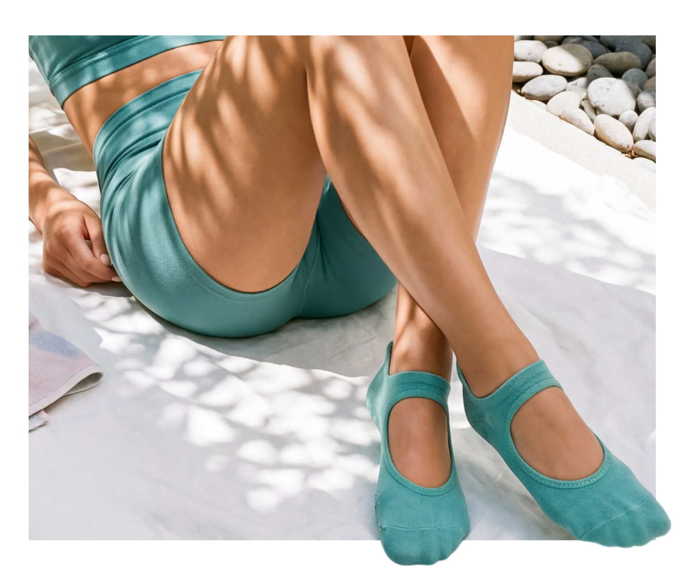 Woman wearing white Satori grip socks with open-heel design on yoga mat, showing non-slip sole for comfort and balance.