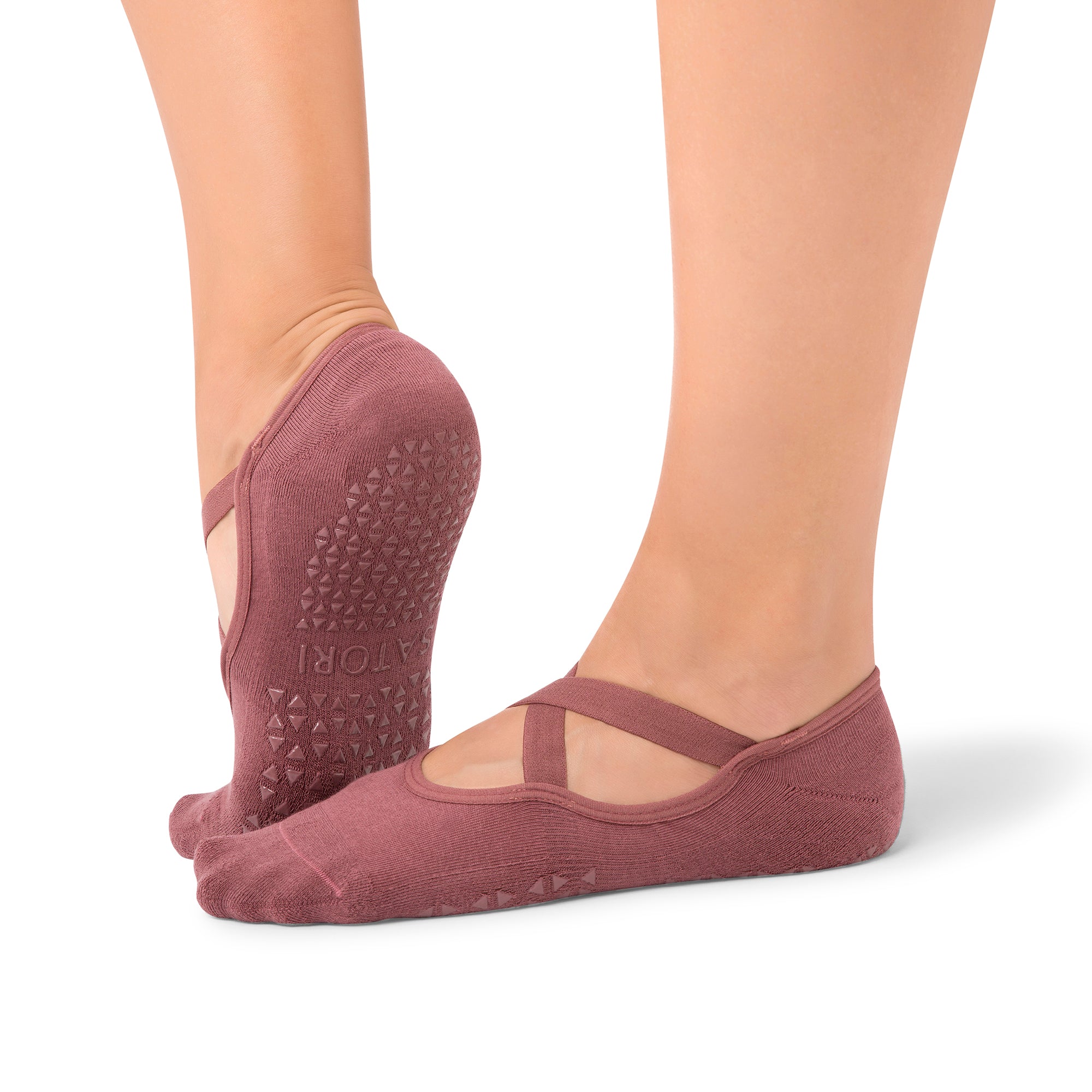 Naomi Acai Berry grip socks on woman’s feet during Pilates class in Dubai