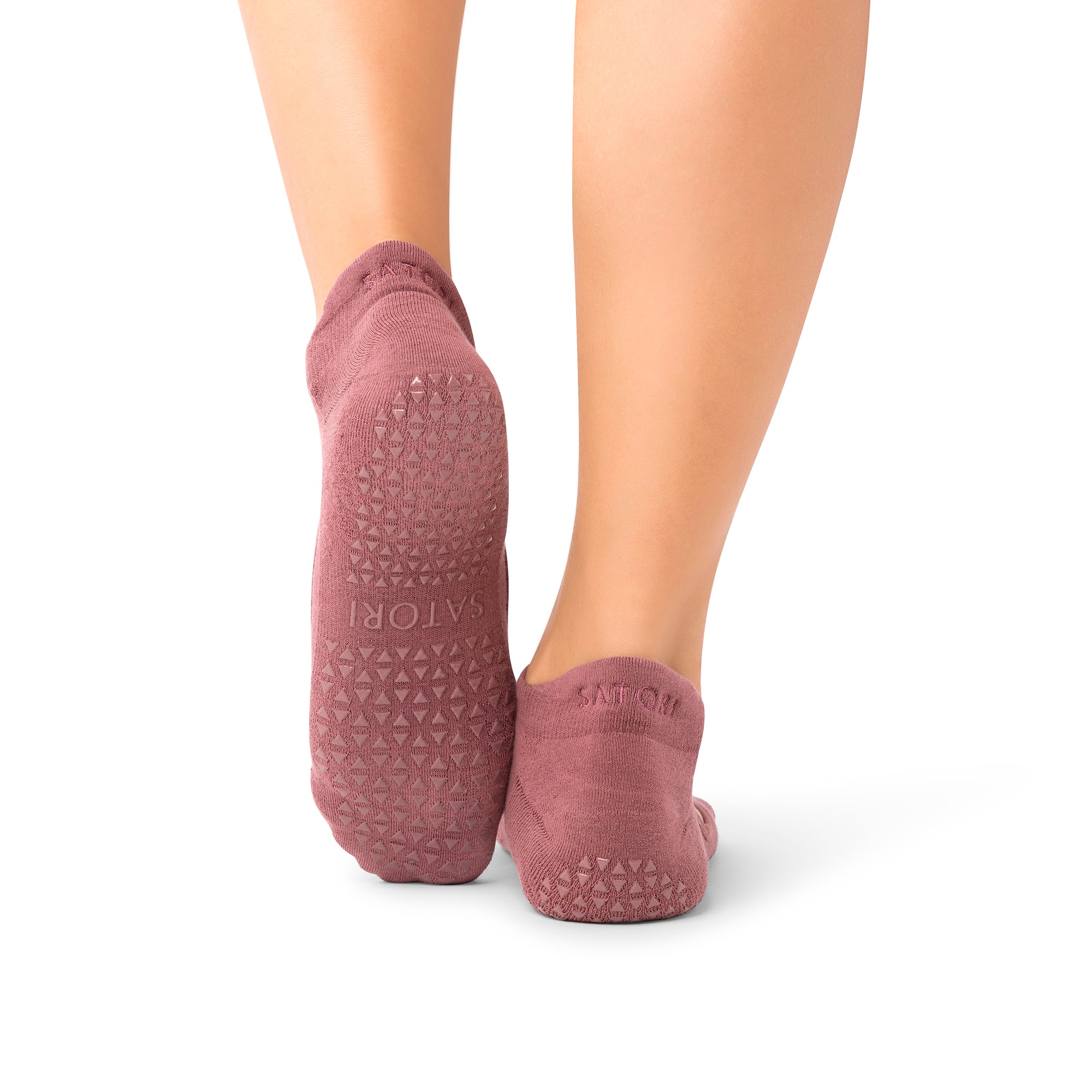 Middle Eastern woman wearing elegant Aya Acai Berry grip socks in yoga class