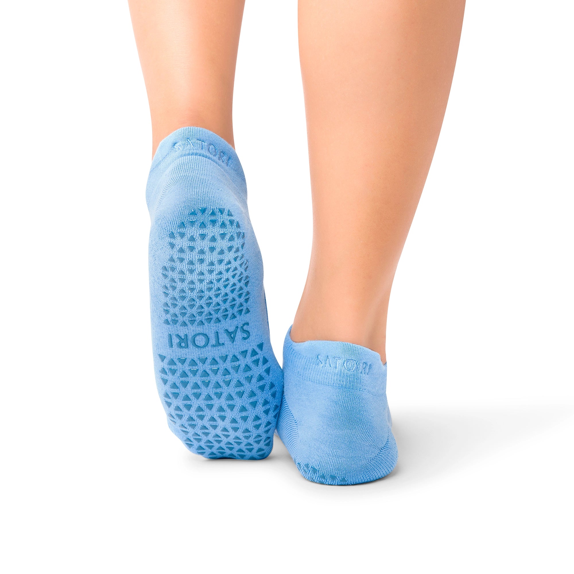 Middle Eastern woman wearing elegant Aya Azure grip socks in yoga class