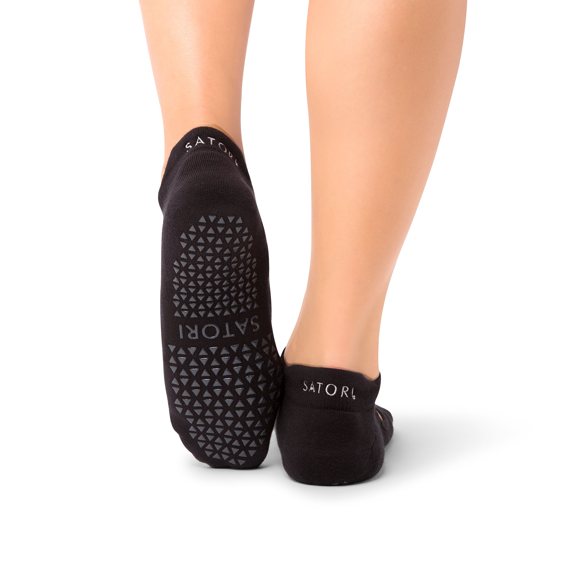 Middle Eastern woman wearing elegant Aya Midnight grip socks in yoga class