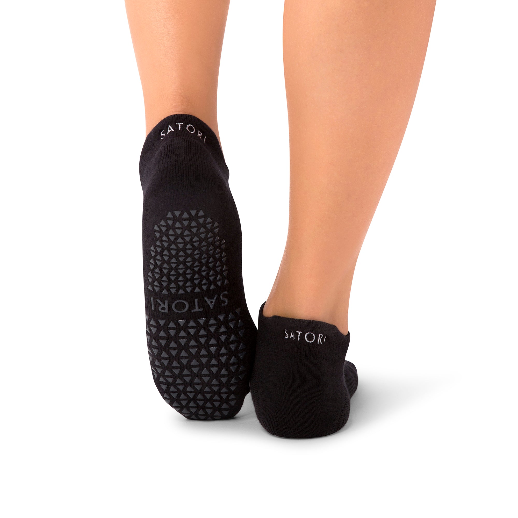 Hana Midnight grip socks supporting a Pilates pose in a Middle Eastern studio