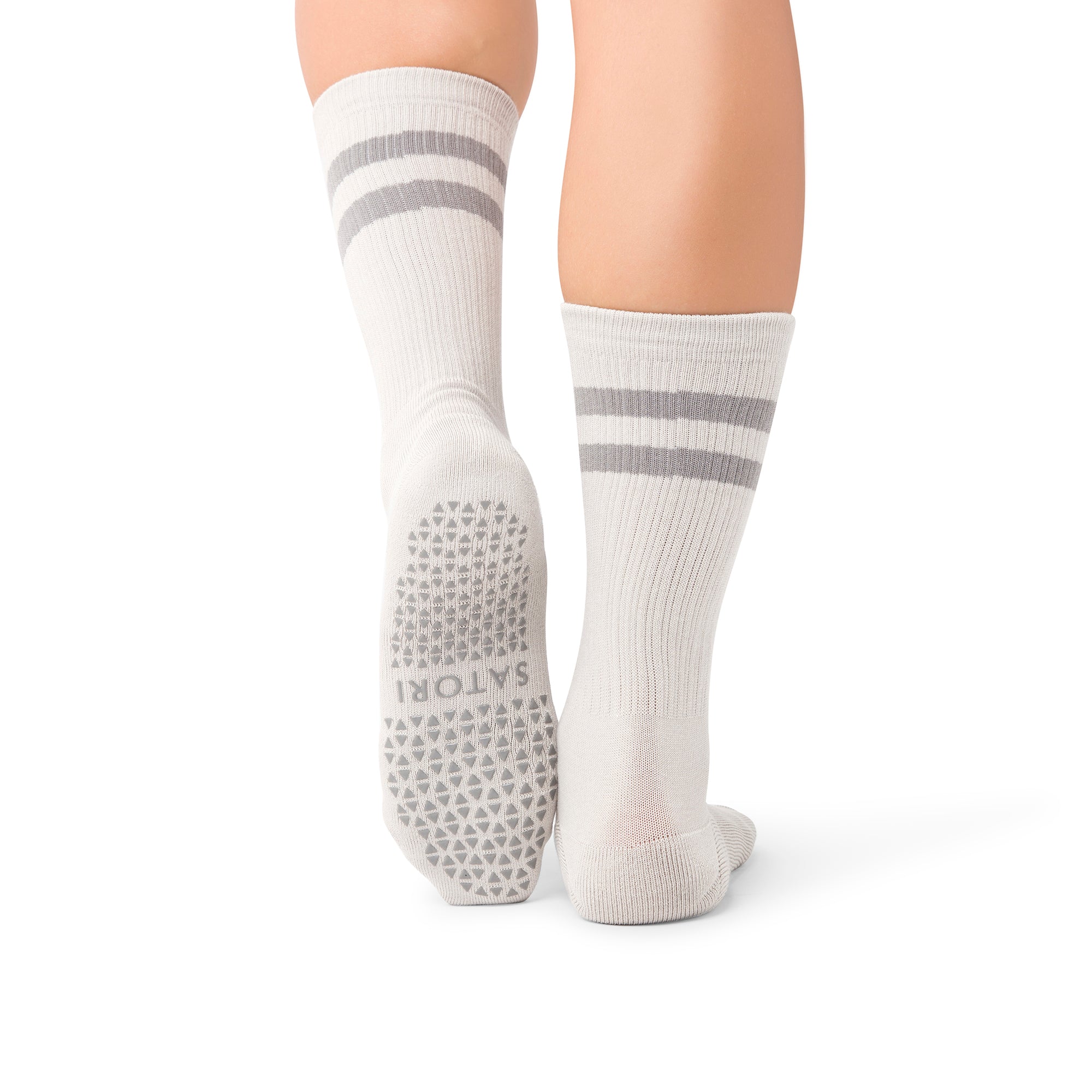 Close-up of Mio Faded Ash crew grip socks on yoga mat in a GCC studio