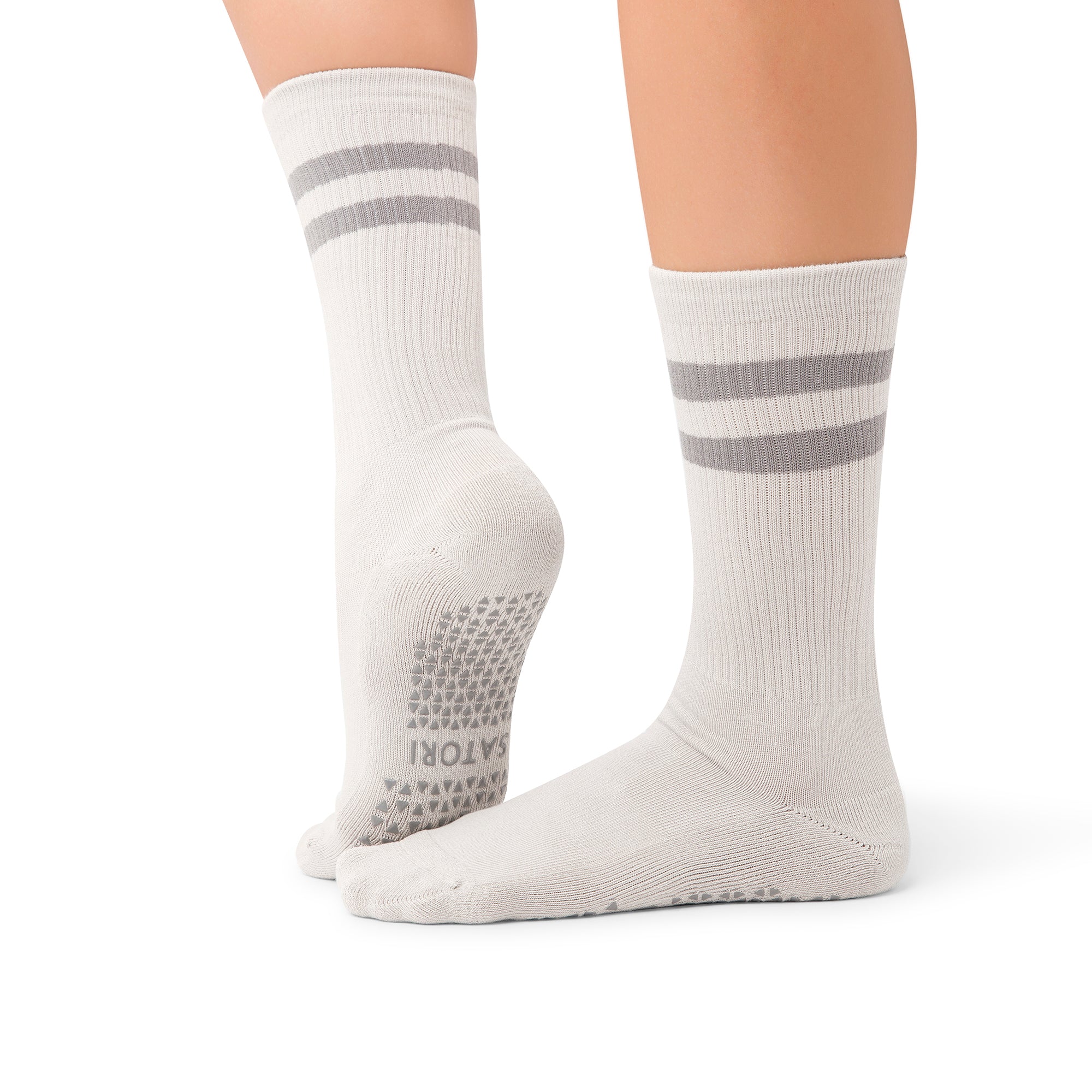 Close-up of Mio Faded Ash crew grip socks on yoga mat in a KSA studio