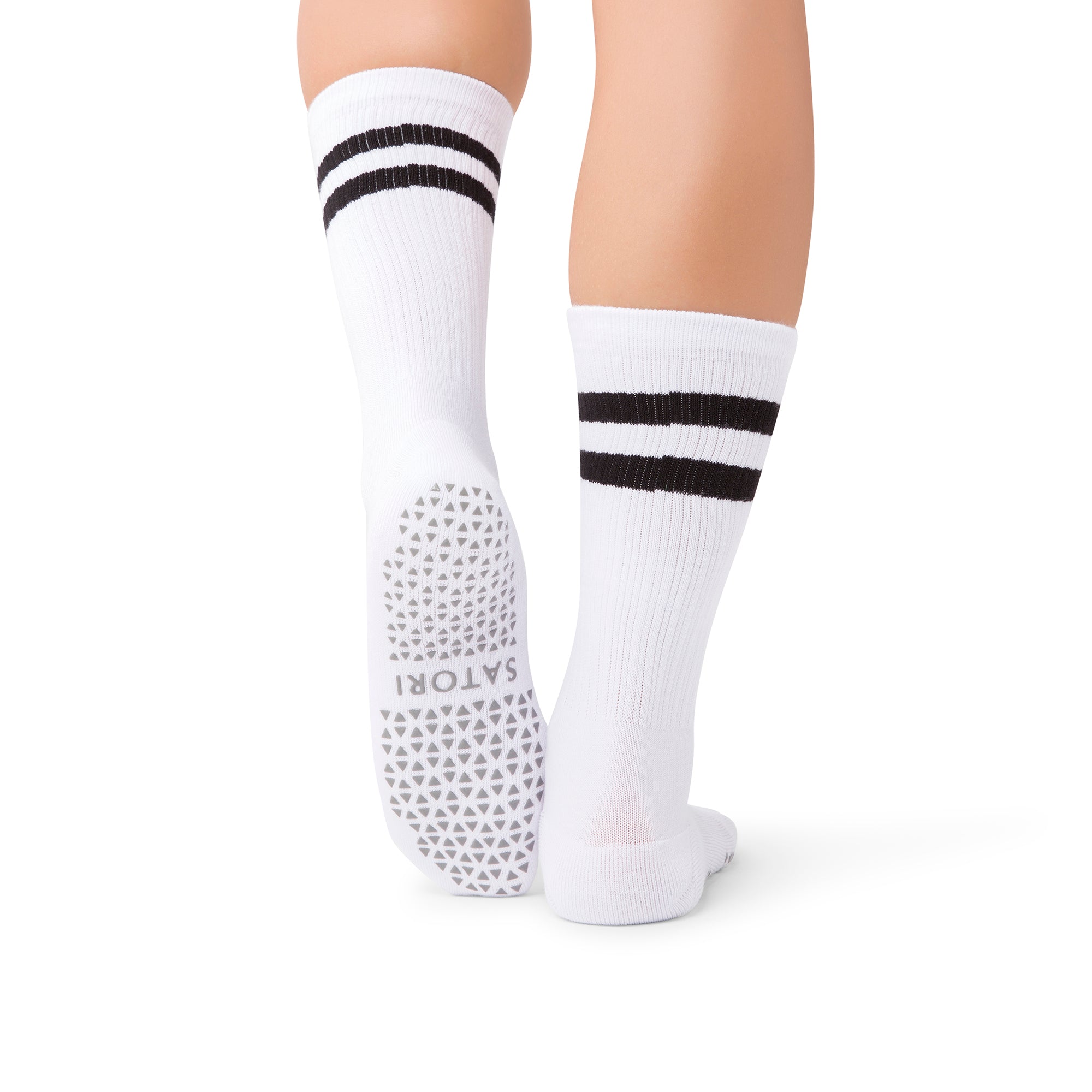 Mio Ivory Luxe grip socks in a middle east barre studio setting