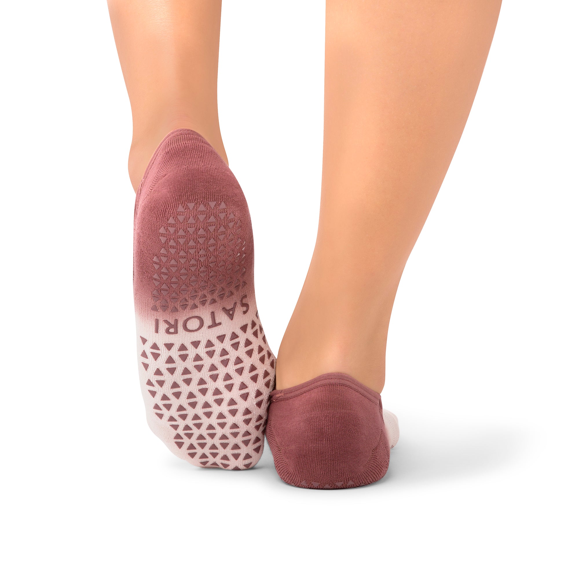 Naomi Acai Berry Ombre grip socks on woman’s feet during Pilates class in the Dubai