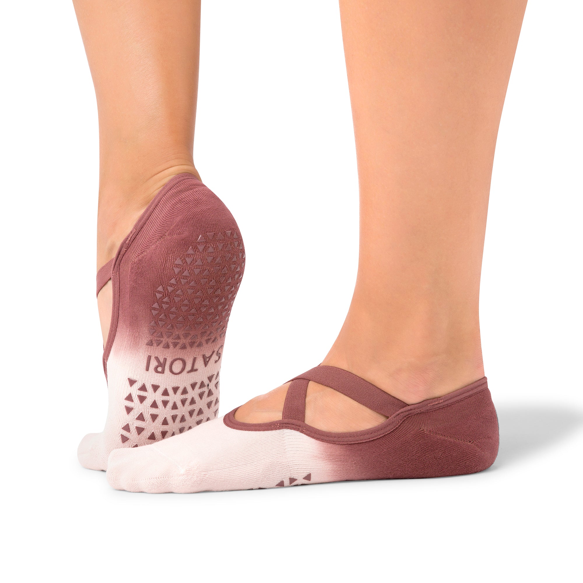 Naomi Acai Berry Ombre grip socks on woman’s feet during Pilates class in the UAE