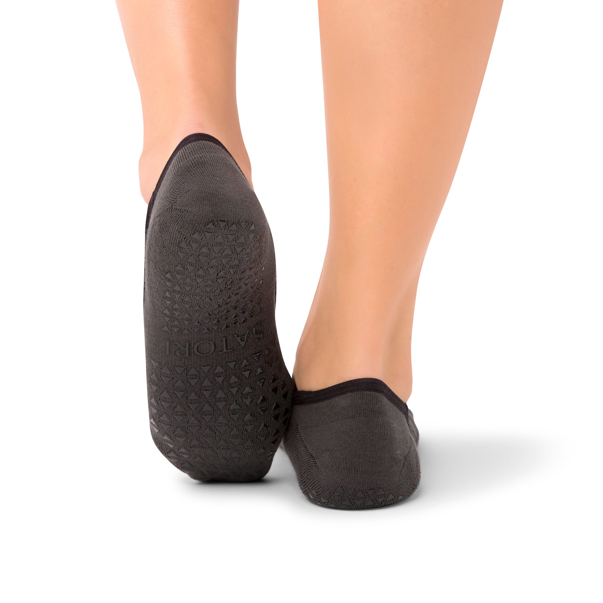 Close-up of Naomi Anthracite grip socks worn during a barre class in a  GCC