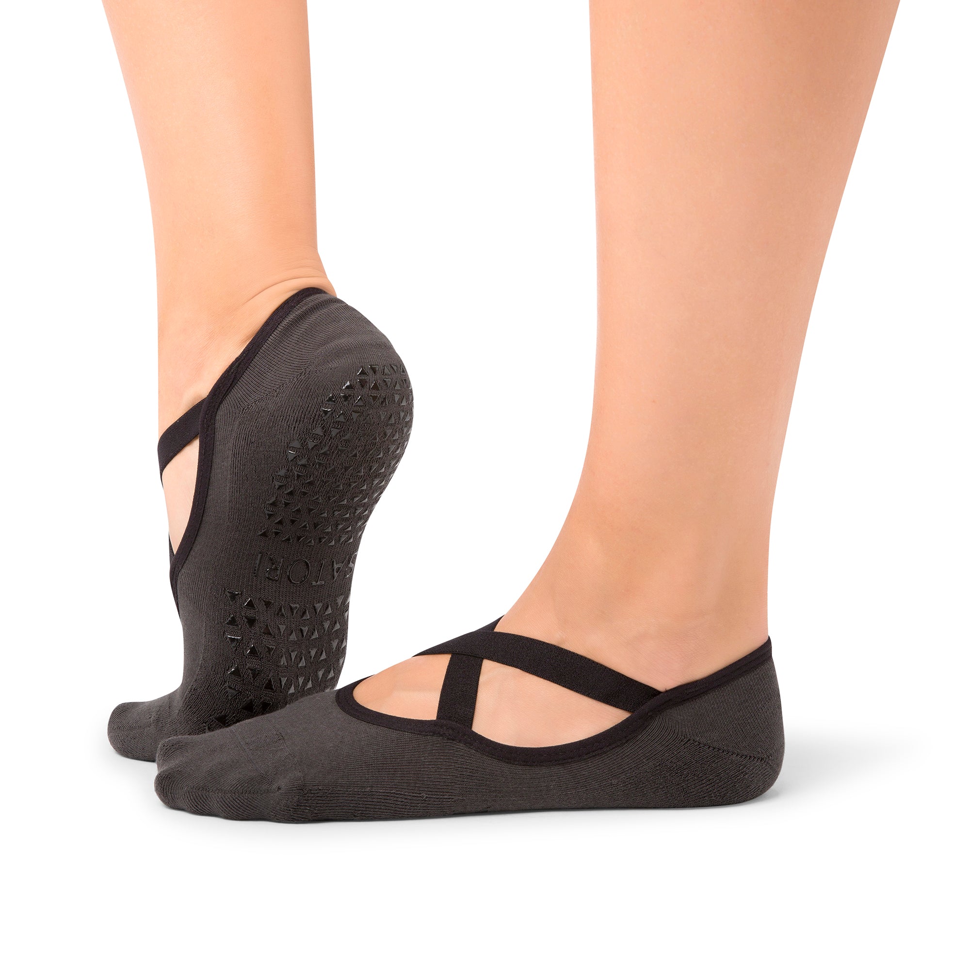 Close-up of Naomi Anthracite grip socks worn during a barre class in a Middle East