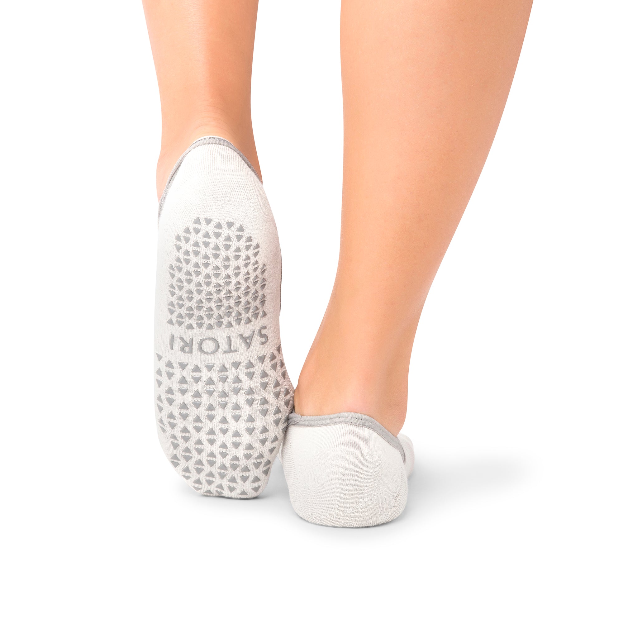 Faded Ash Naomi grip socks with ballet-style straps on a yoga mat in GCC
