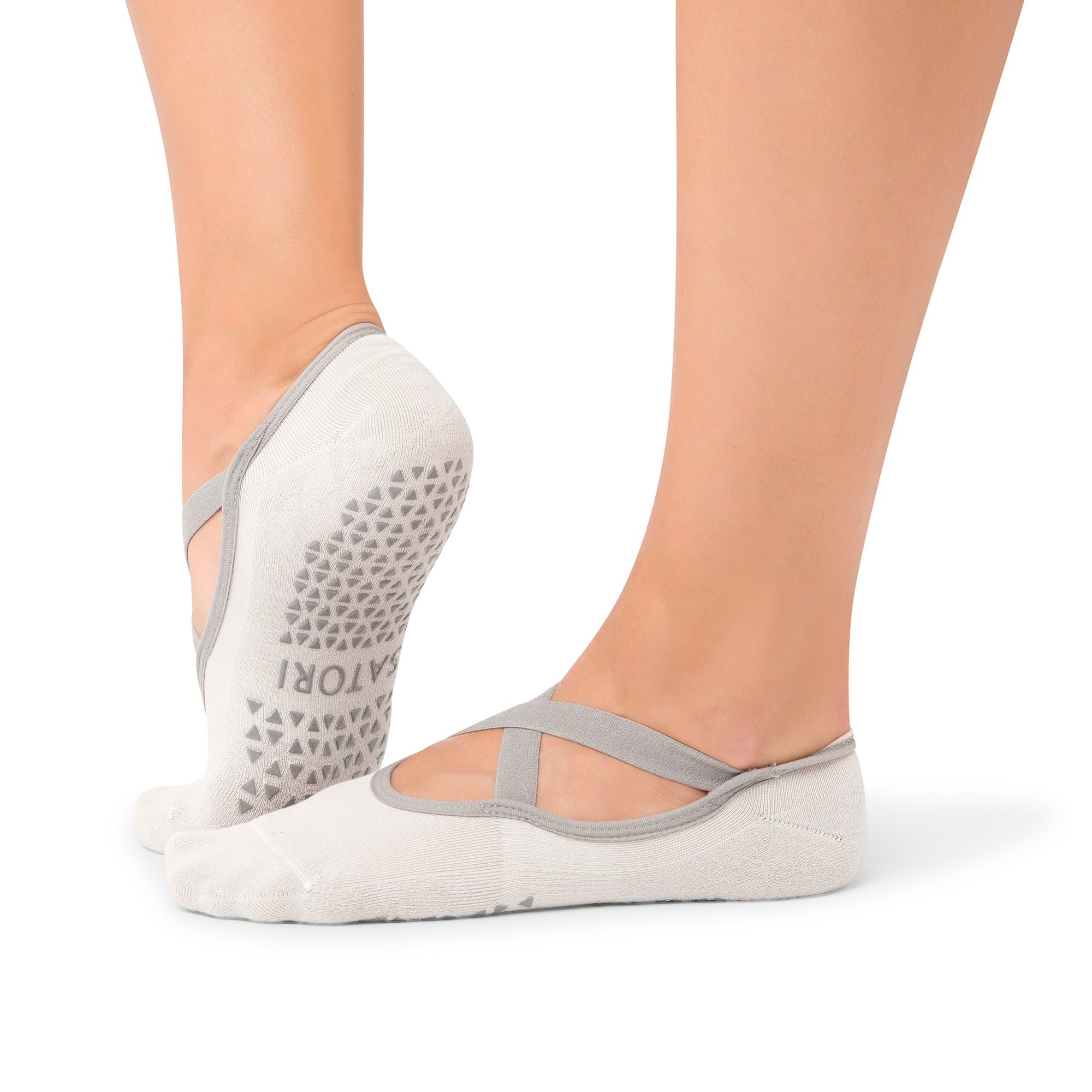 Faded Ash Naomi grip socks with ballet-style straps on a yoga mat in Middle East.