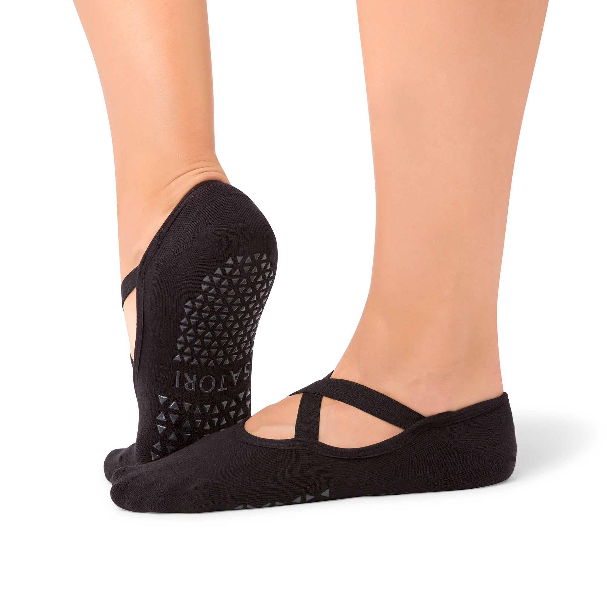 Naomi Midnight grip socks on woman’s feet during Pilates class in the Middle East