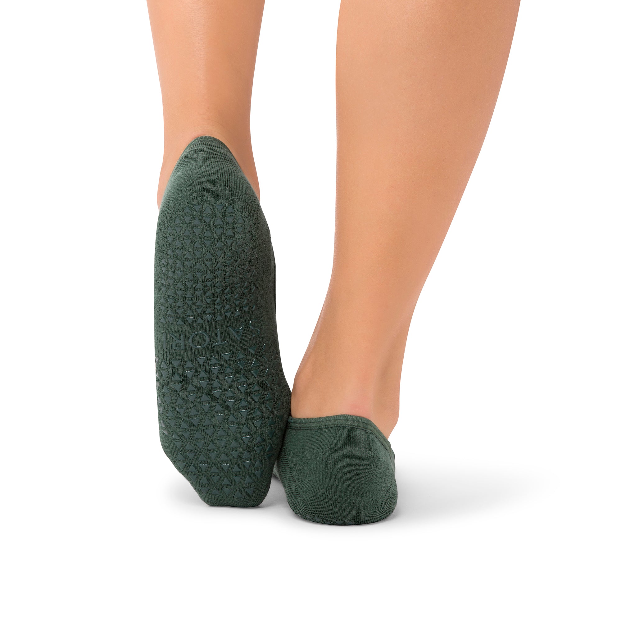 Middle Eastern woman wearing Naomi Mystic Jade grip socks during Pilates