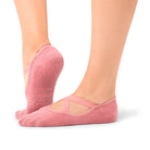 Woman wearing Naomi Rosewood grip socks during a barre class in Dubai