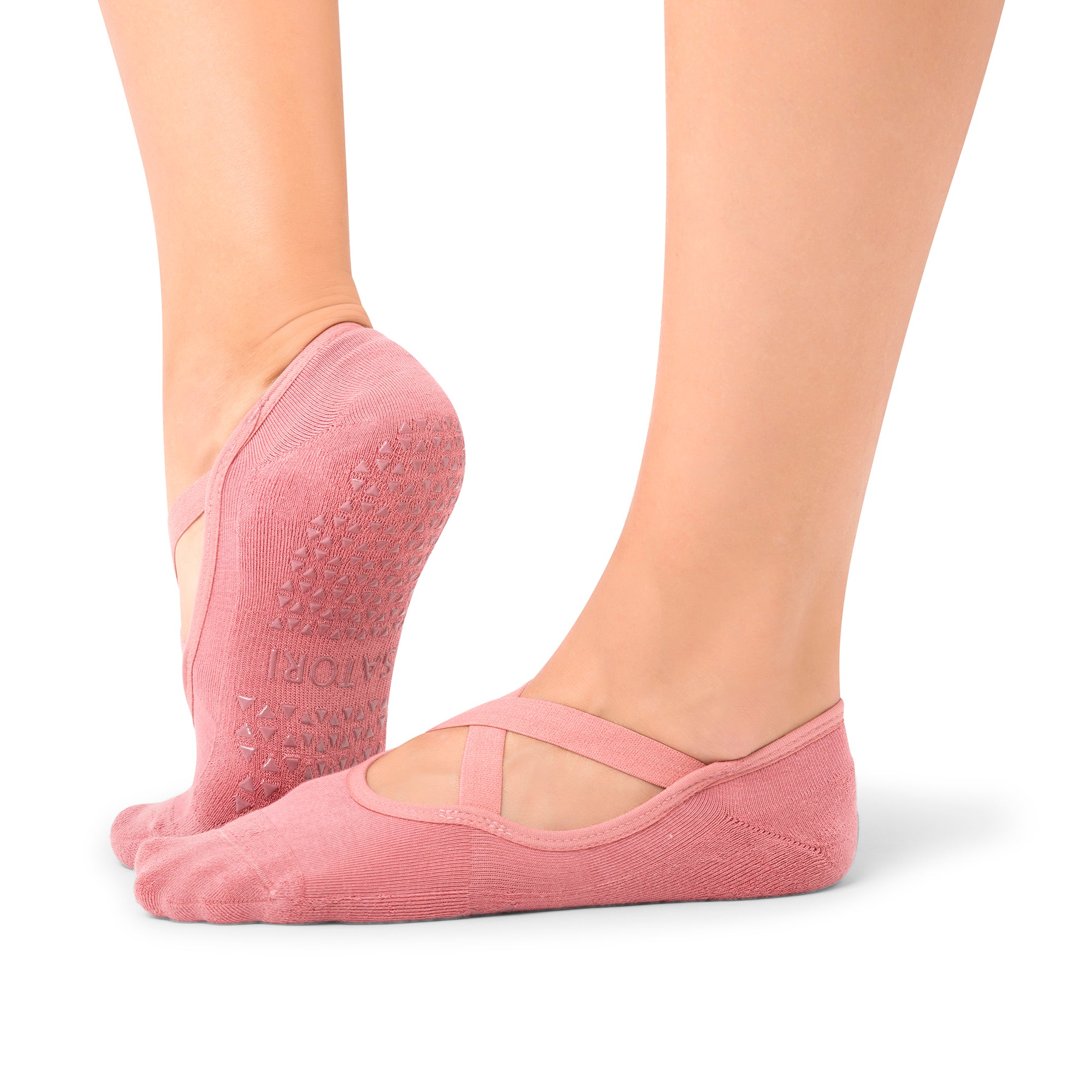 Woman wearing Naomi Rosewood grip socks during a barre class in Dubai