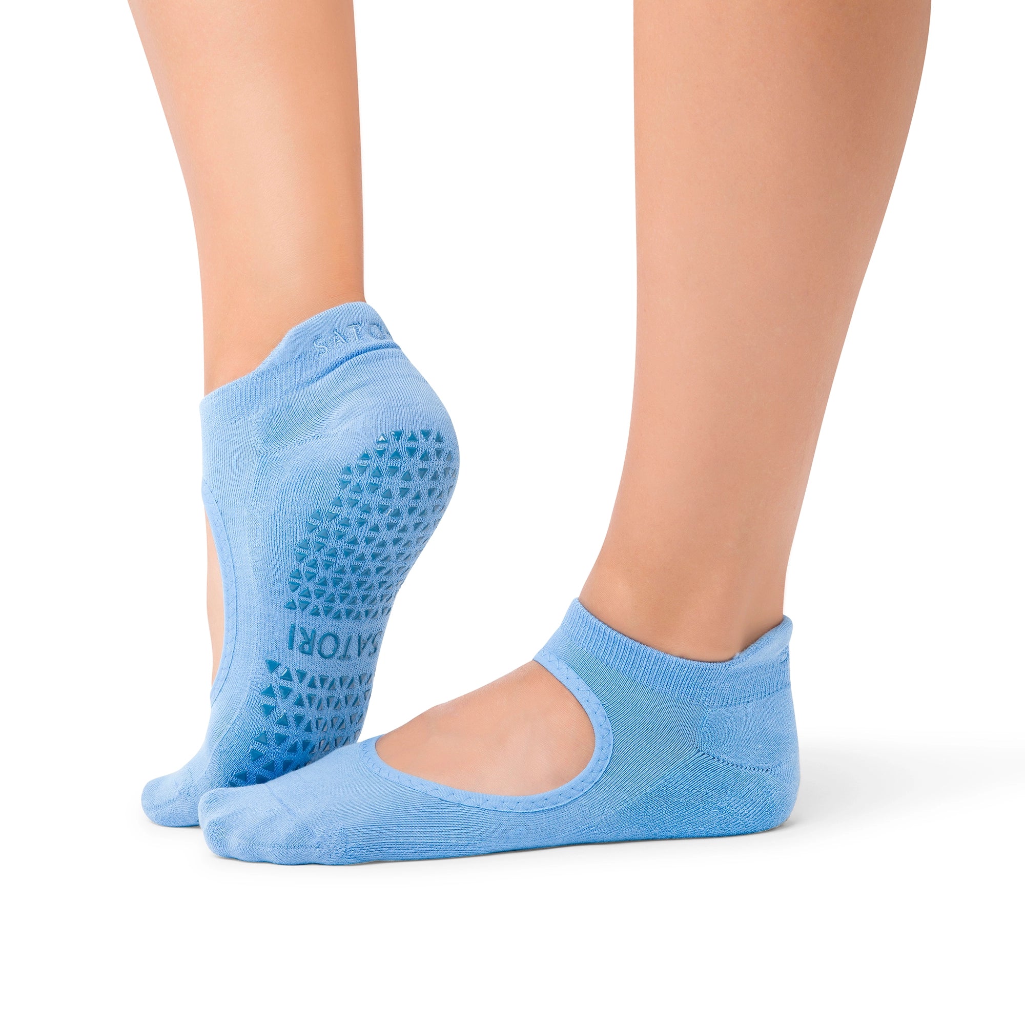Close-up of organic Azure Aya grip socks on wooden floor during Pilates