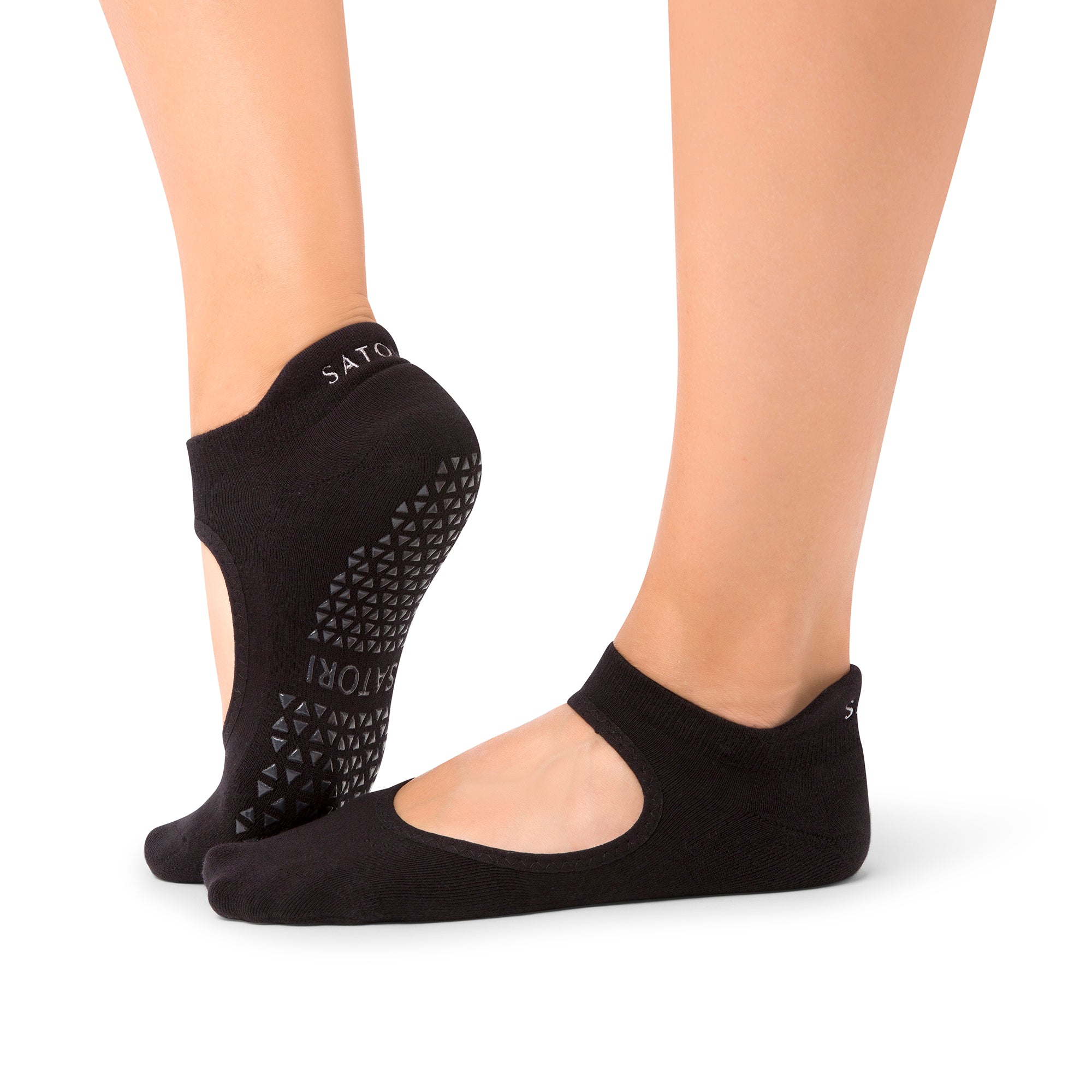 Close-up of organic Azure Aya grip socks on wooden floor during Pilates